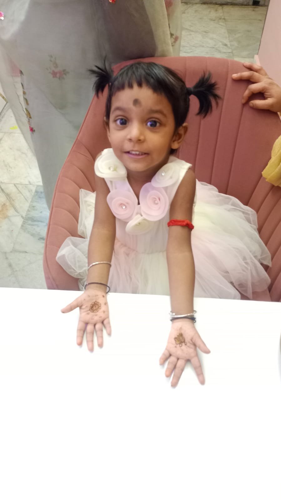 Little girl with mehendi on hands